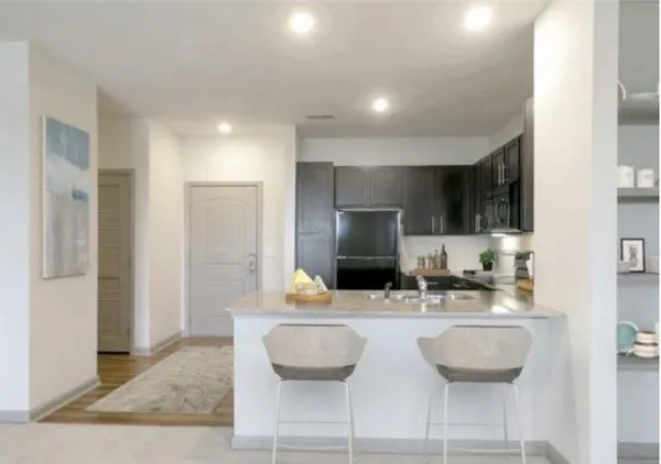 a kitchen with a sink cabinets and refrigerator