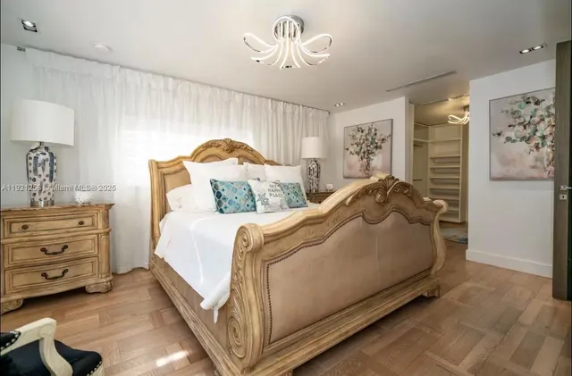 a bed room with a bed and a chandelier
