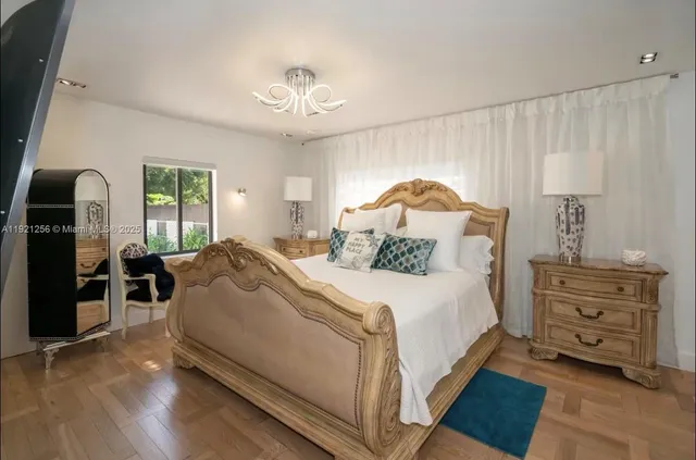 a bedroom with a bed and a chandelier