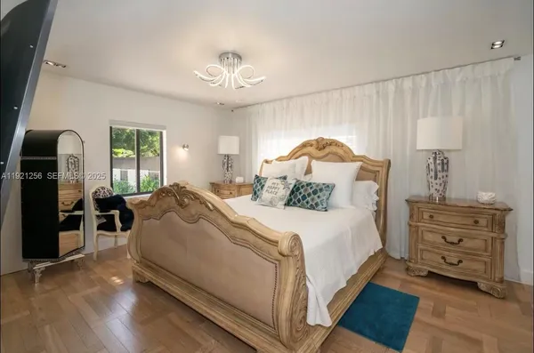 a bedroom with a bed and a chandelier