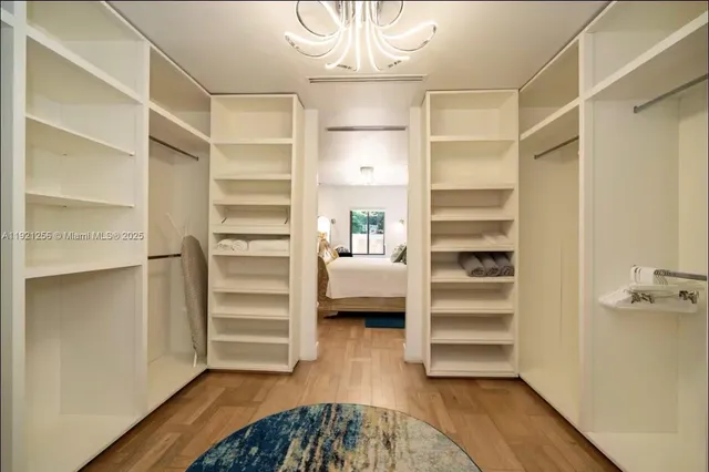 a view of walk in closet with empty racks