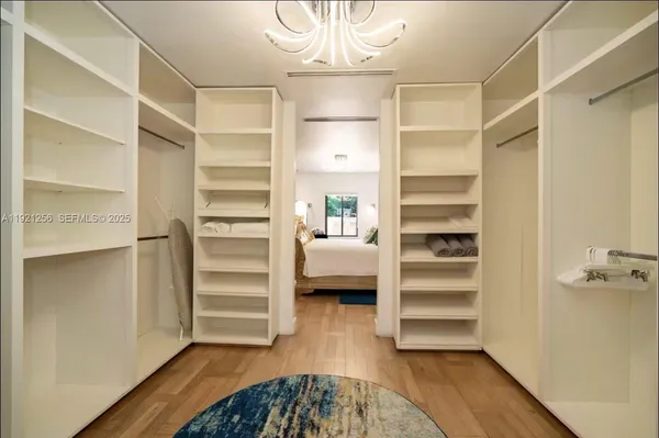 a view of walk in closet with empty racks