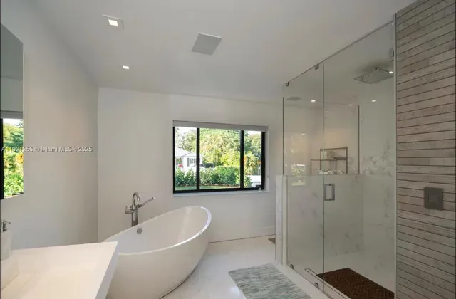 a bathroom with a bathtub and shower