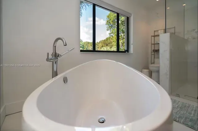 a bathroom with a tub and a window