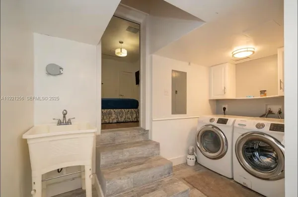 a utility room with sink dryer and washer