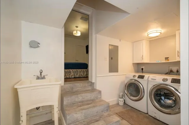 a utility room with sink dryer and washer