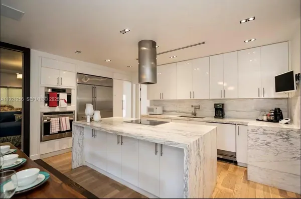 a kitchen with a sink a stove and cabinets