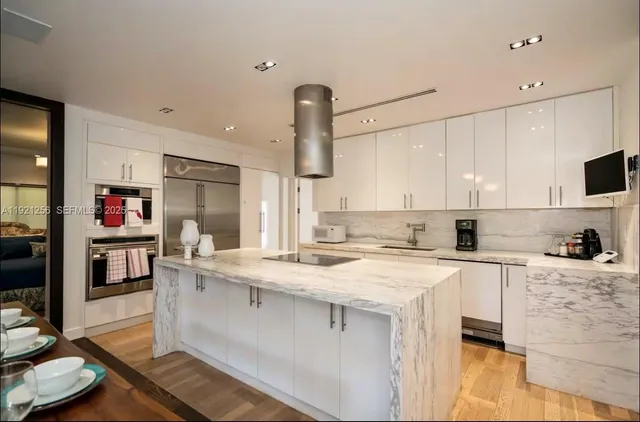 a kitchen with a sink a stove and cabinets
