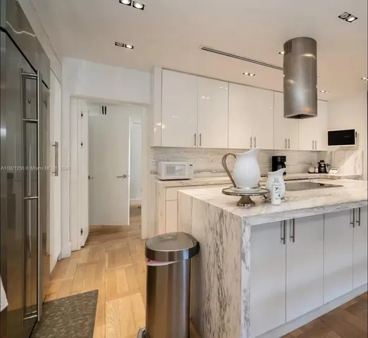 a kitchen with a sink a refrigerator and cabinets