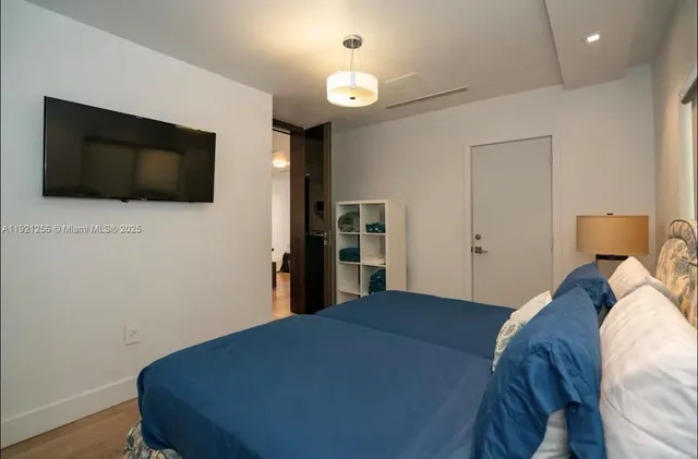 a bed room with a bed and a television