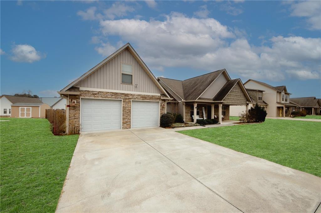 229 Gilmore Circle Calhoun, GA 30701 - Photo 1 of 1 a front view of a house with a yard and garage