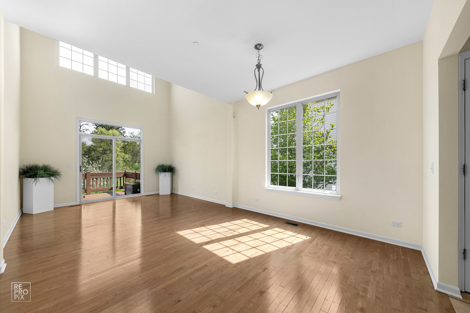 6400 Cunningham Court Gurnee, IL 60031 - Photo 3 of 19 a view of an empty room with wooden floor and a window