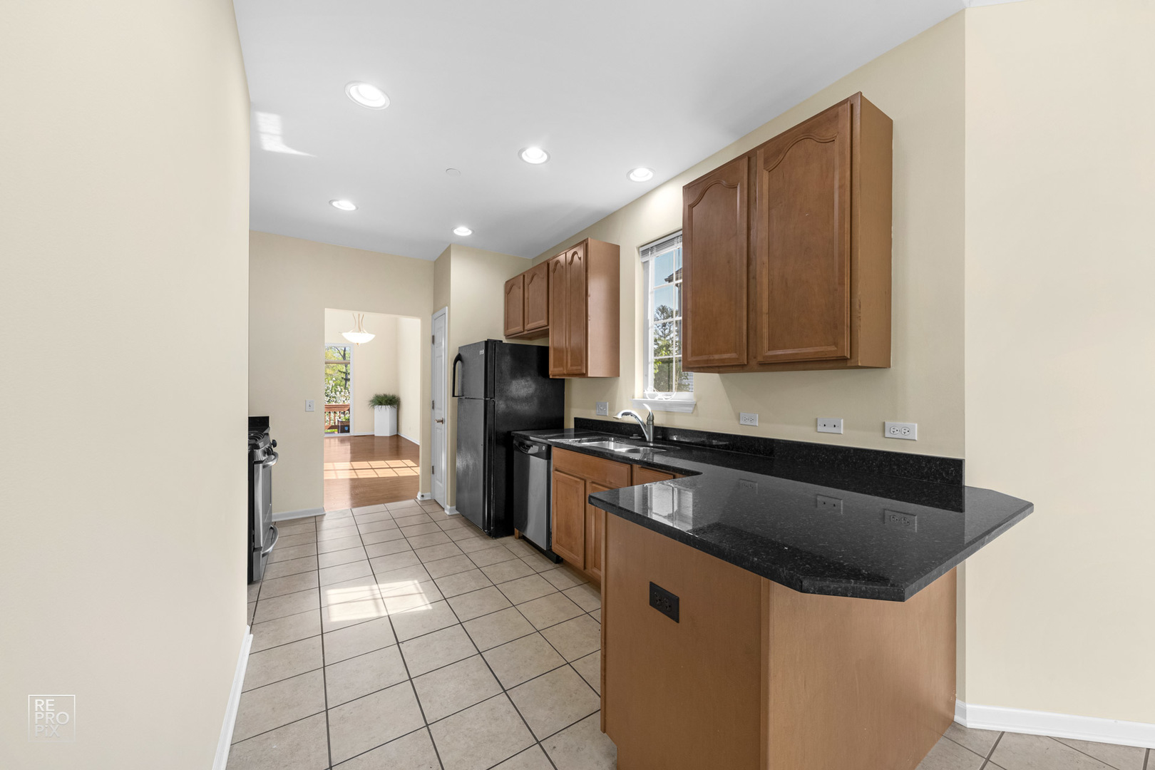 6400 Cunningham Court Gurnee, IL 60031 - Photo 8 of 19 a kitchen with stainless steel appliances granite countertop a sink a stove a refrigerator and a microwave