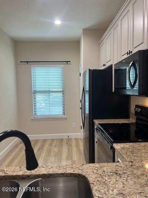 669 South Orange Street Starke, FL 32091 - Photo 12 of 12 a kitchen with a refrigerator and a stove