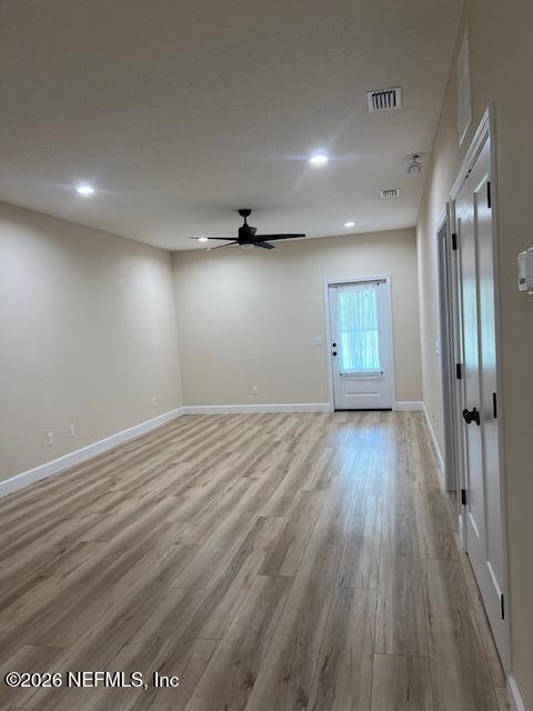669 South Orange Street Starke, FL 32091 - Photo 6 of 12 an empty room with wooden floor and windows