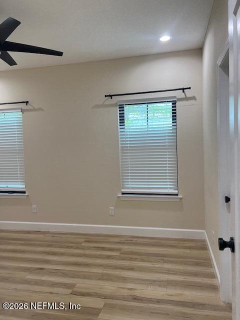 669 South Orange Street Starke, FL 32091 - Photo 8 of 12 a view of an empty room with wooden floor and a window