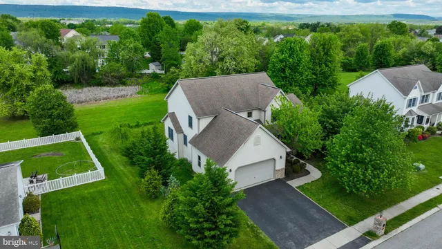 an aerial view of a house with yard