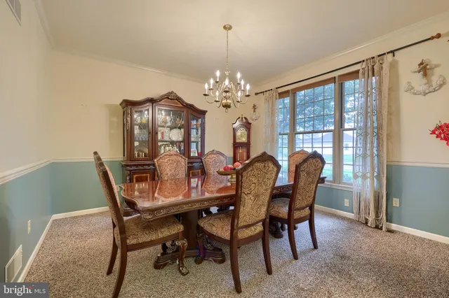 a view of a dining room with furniture wooden floor and a chandelier