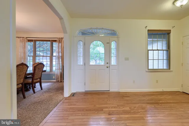 a view of a dining room with furniture and chandelier