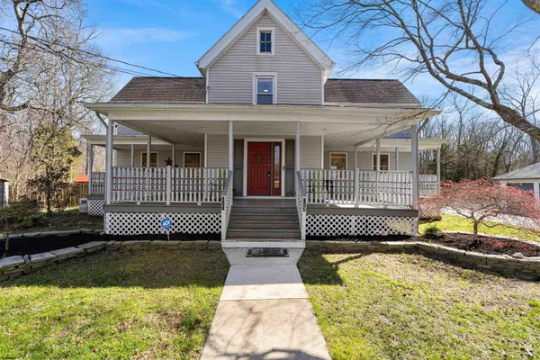 a front view of a house with a yard and glass doors