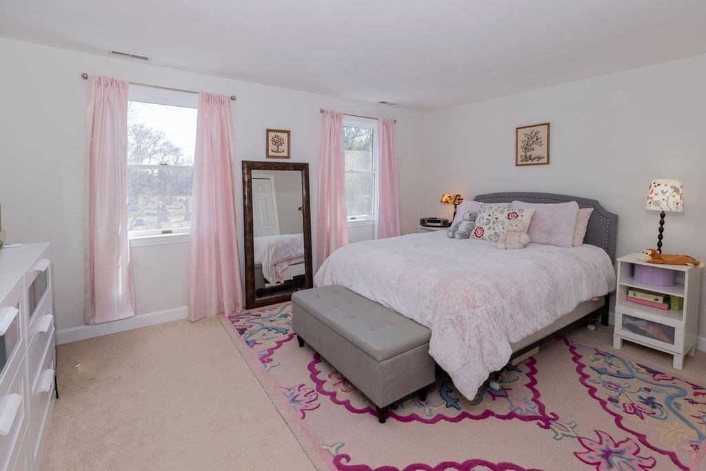 126 Lafayette Street Marblehead, MA 01945 - Photo 20 of 30 a bedroom with a bed and wooden floor