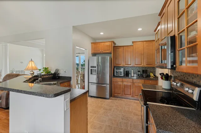 a kitchen with refrigerator and cabinets