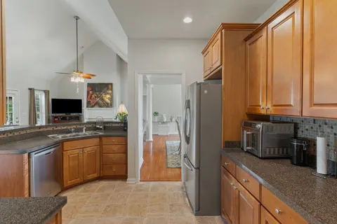 a kitchen with stainless steel appliances granite countertop a refrigerator and a sink