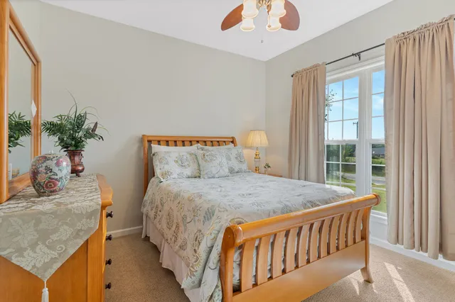 a bed sitting in a bedroom next to a window