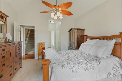 a bedroom with a bed and a chandelier