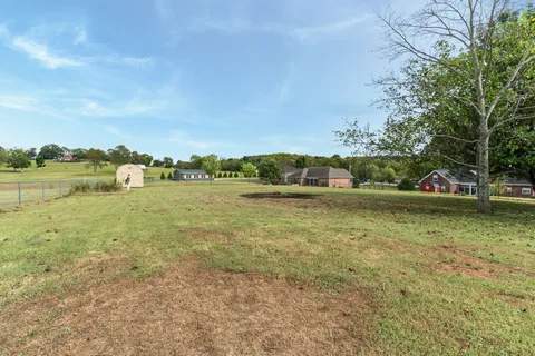a view of a lake with houses in background