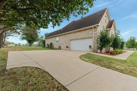 a view of a house with a yard and garage