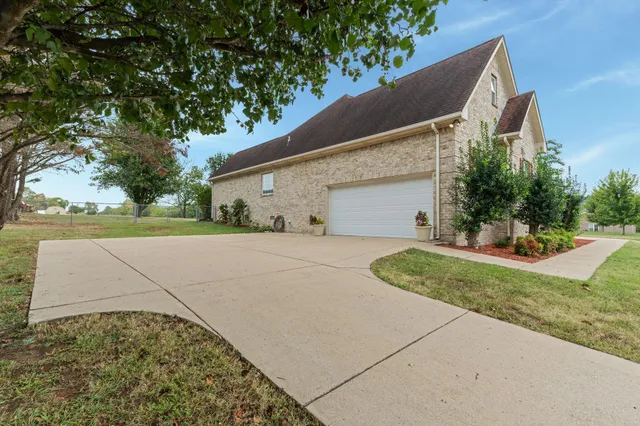 a view of a house with a yard and garage