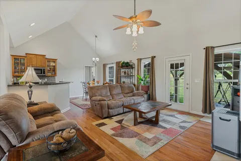 a living room with furniture and wooden floor