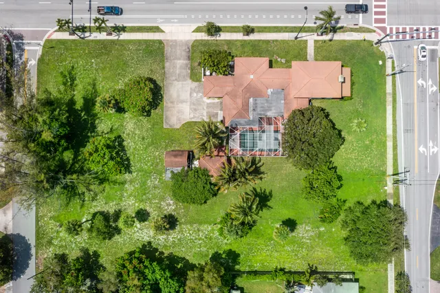 an aerial view of a house with a garden and yard