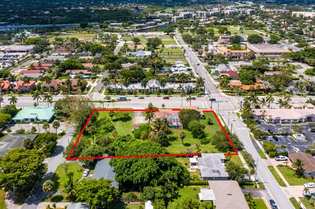 an aerial view of residential houses with outdoor space and swimming pool
