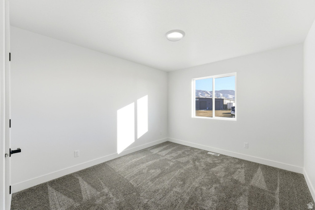 645 West 880th Street South Fillmore, UT 84631 - Photo 17 of 22 Room featuring light gray patterned carpeting, white walls, and a modern flush-mount ceiling light