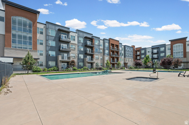 8248 South Resaca Drive, Unit J10 Sandy, UT 84070 - Photo 25 of 40 Expansive concrete patio surrounding a resort-style swimming pool and integrated spa