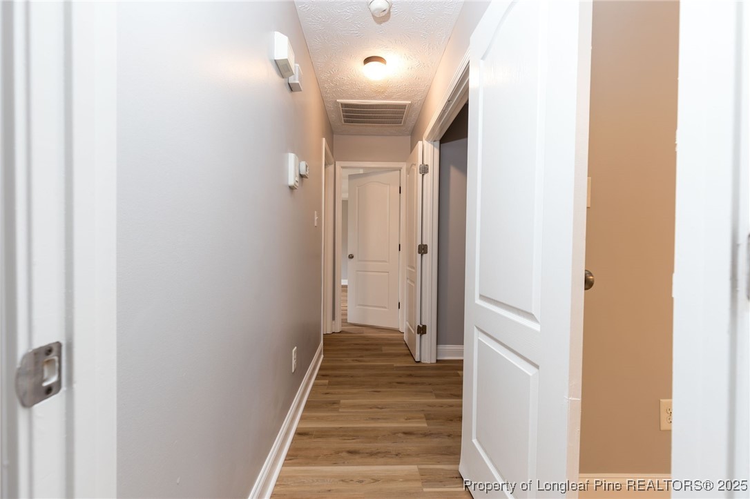 3192 Braddy Road Fayetteville, NC 28306 - Photo 11 of 20 a view of a hallway with wooden floor and staircase