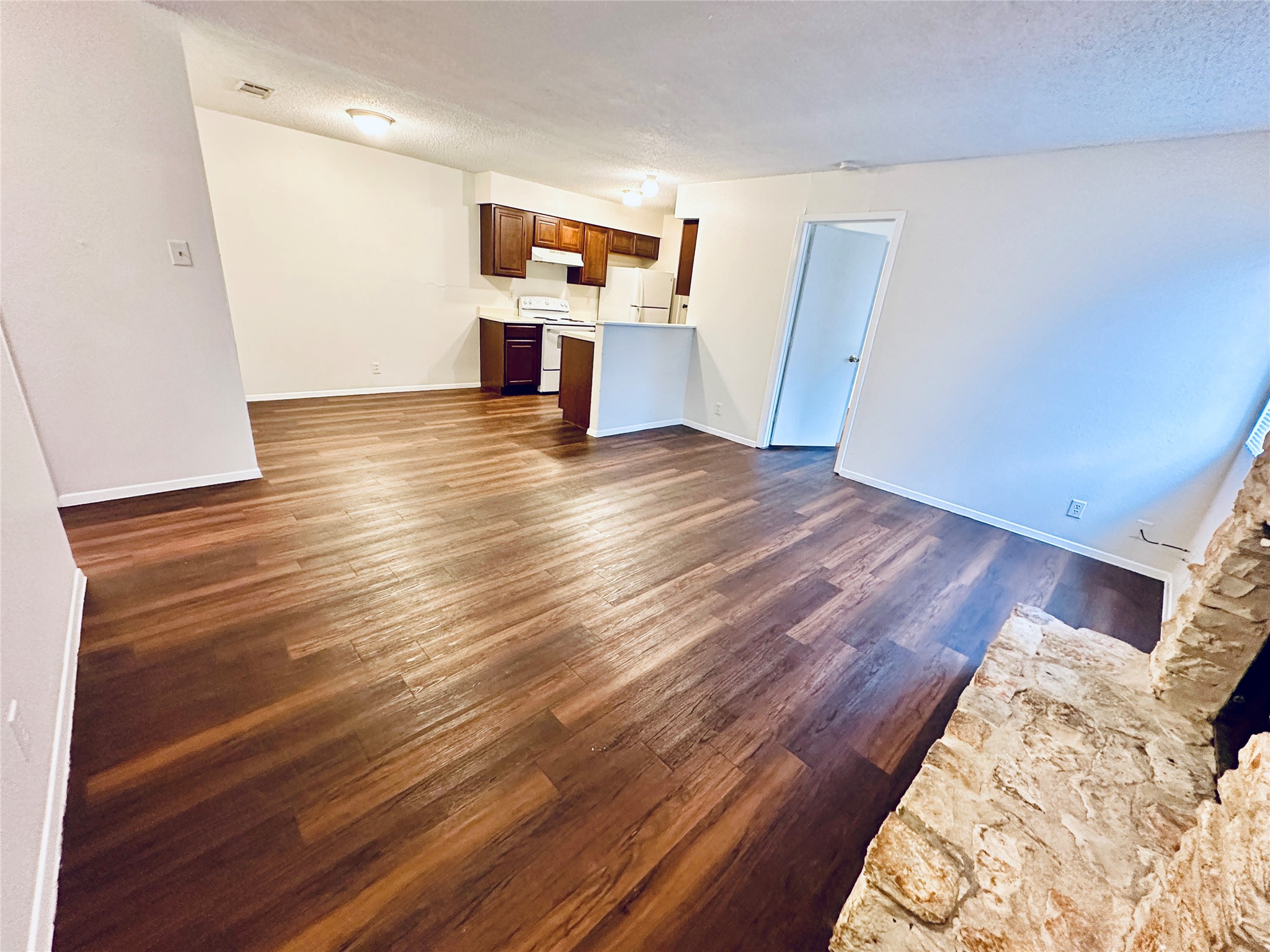 12505 Turtle Rock Road, Unit A Austin, TX 78729 - Photo 12 of 38 Hardwood-style flooring extends from the living space into the open kitchen.