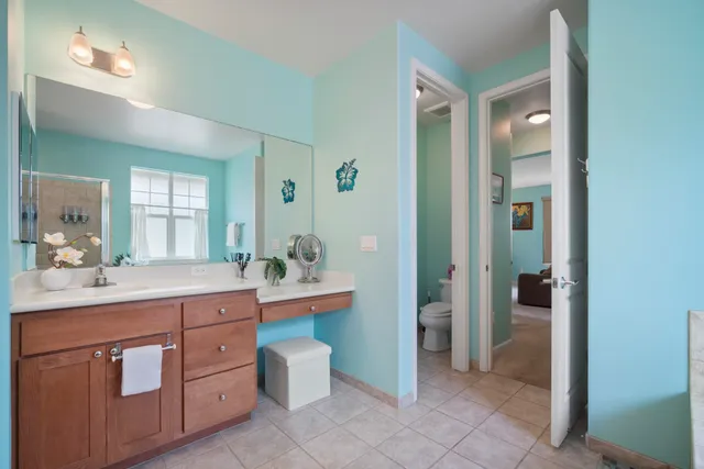 a spacious bathroom with a granite countertop sink mirror and toilet