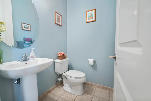 a bathroom with a sink mirror and toilet