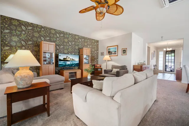 a living room with furniture flowerpot and window