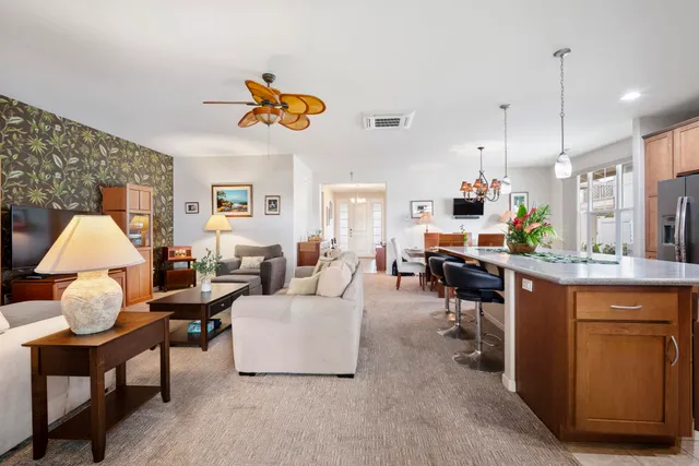 a living room with furniture and a chandelier