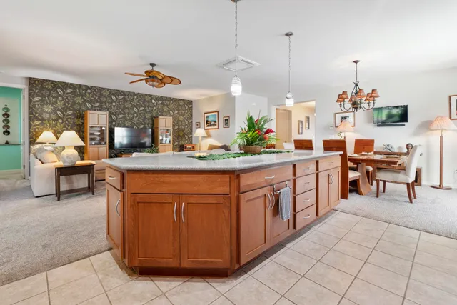 a dining hall with a sink and living room view