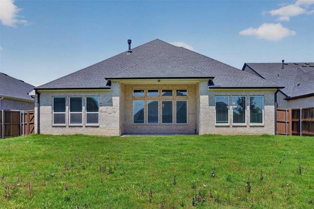 16812 Bitterroot Road Justin, TX 76247 - Photo 27 of 27 front view of a brick house with a yard