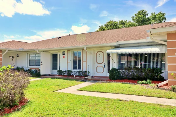 a front view of a house with garden