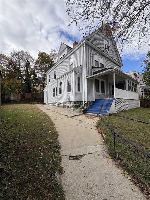 547 Talbot Avenue Boston, MA 02124 - Photo 1 of 14 a view of a white house with a big yard and large trees