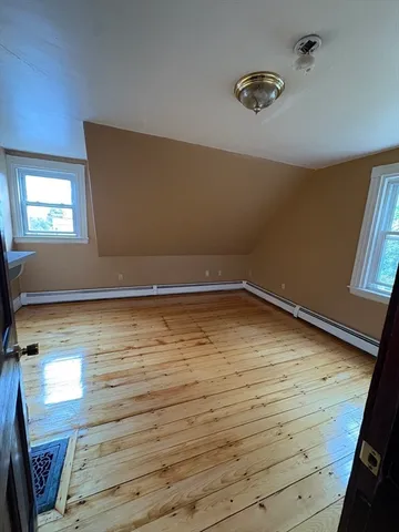 a view of room with window and hardwood floor