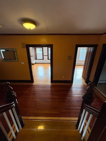 a view of an empty room and wooden floor