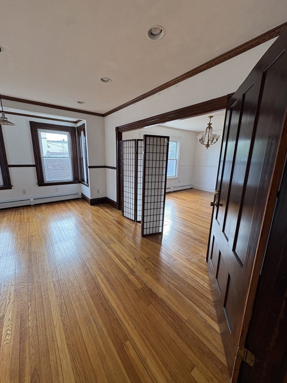 547 Talbot Avenue Boston, MA 02124 - Photo 6 of 14 a view of empty room with wooden floor and fan